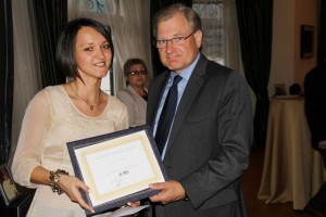 FLEX Program Coordinator Kristi Milorava ’07 receives the award from Ambassador Norland for her success in the speed networking session.